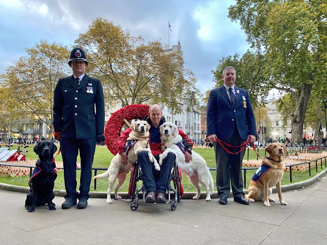 PC Damian Malone, Founder of Hounds for Heroes Allen Parton and ex-military Doug Richie with their assistance dogs ahead of the parade