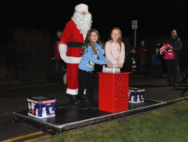 Holly Atkin and Liberty Shepherd turning on the Christmas lights in Whitworth with Father Christmas