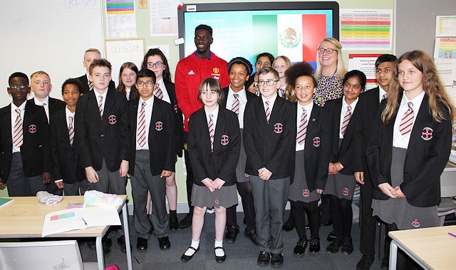 Axel Tuanzebe with students from St Cuthbert's RC High School