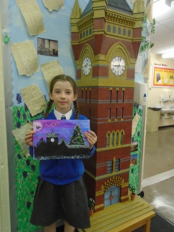 Year Four pupil Imogen O'Brien with her winning design in front of a scaled-down Birch Hill