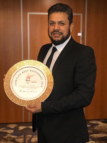 The Milnrow Balti owner Mohammed with his award