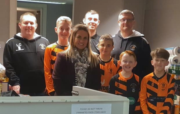 Players and coaches from Roach Dynamos drop donations at Heywood Foodbank