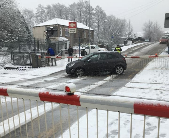 The car stuck on the line at Smithy Bridge Railway Station