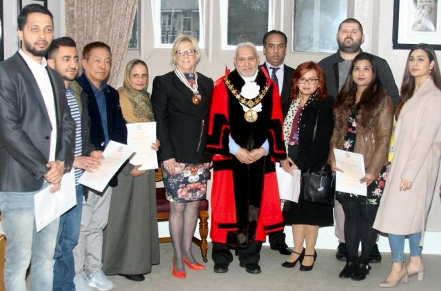 Mayor Mohammed Zaman presenting certificates at the British Citizenship Registrars presentation