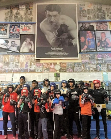 Hamer youngsters under a giant-sized picture of their hero, Jock McAvoy
