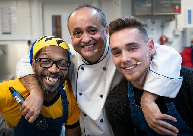 Local chefs Austin Hopley and Adolfus Lewis are congratulated by festival kitchen host Aazam Ahmad after completing their demonstration