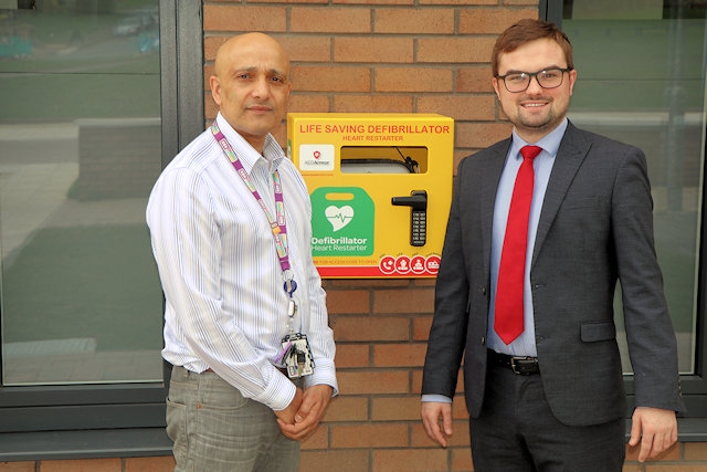 Fida Hussain with Councillor Meredith and the new defibrillator at Kirkholt