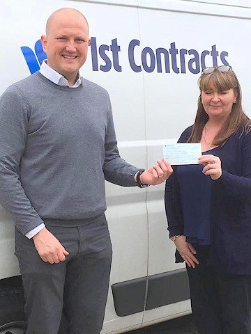 Leon Ashworth, from 1st Contracts, hands over a cheque for materials to Hayley Thompson, of Yeomans Projects.