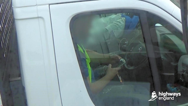 Shocking image of a pick-up truck driver seen with both hands on his phone as he writes a text message