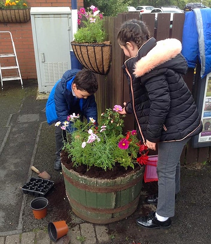 Children get stuck in planting flowers