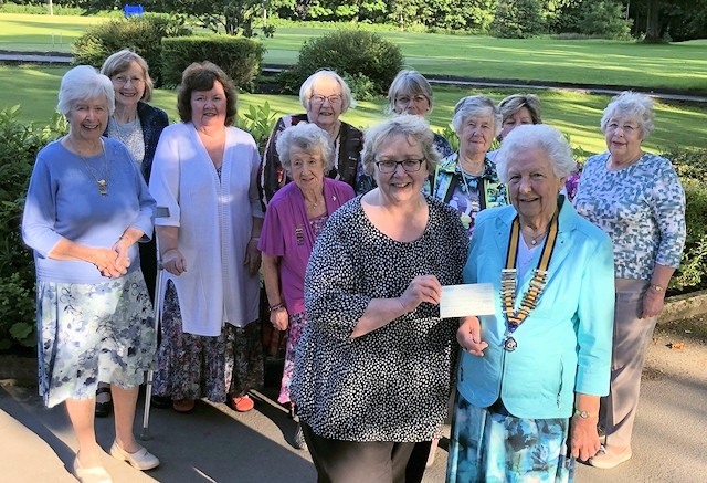 Brunhilde Kay of the Inner Wheel of Middleton presents a cheque to Barbara Lloyd representing Springhill Hospice
