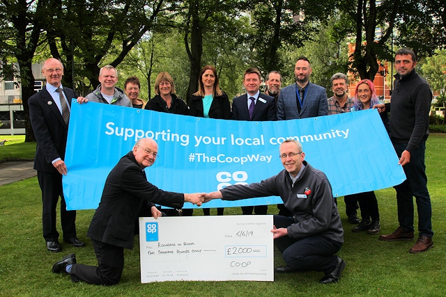 The Rochdale in Bloom committee is presented with a cheque from the Co-op; Carl England presents a cheque to Billy Sheerin