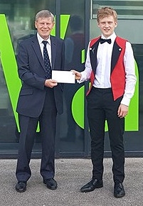 Year 10 student Adam receiving donation from Keith Fairhurst from Rochdale Childer