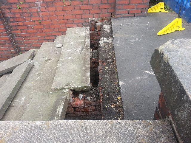 The vandals left a four-foot hole under the steps to the sun gardens