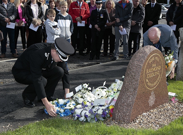 A wreath is laid in memory of Inspector Ray Codling, who was killed on duty at Birch Services