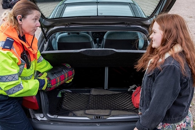 Highways England traffic officer Kelly Rudge checks engine oil with student Shelby Thomas