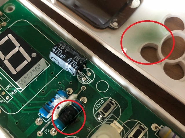 Inside the controller of a heated electric blanket: part of the circuit board overheated, causing burning and discolouration (encircled) which could have led to a fire if it hadn't been noticed in time