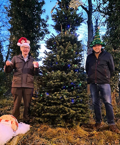 Councillor James Gartside and Paul Ellison with the new Norden Christmas tree