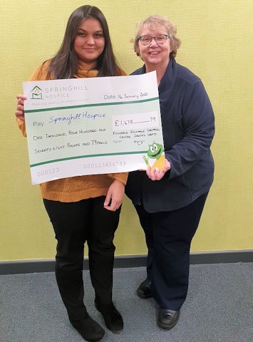 Alima Ahmed-Zaman, operations assistant at Rochdale Exchange, presents Barbara Lloyd from Springhill Hospice with a cheque for £1,478.79