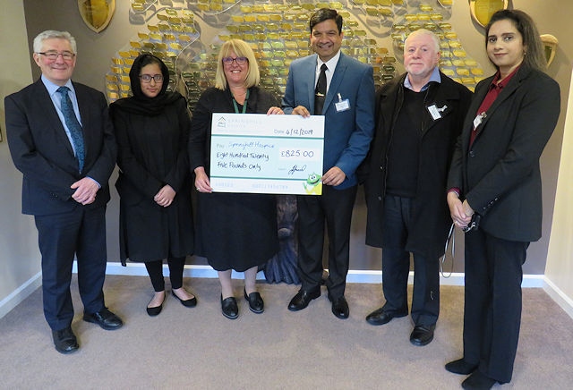 Councillor Faisal Rana and his wife Iram present a cheque to Springhill Hospice