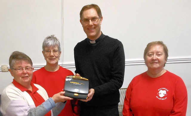 Rochdale Heartbeat presenting St Aidan’s Church in Sudden with a defibrillator in 2020