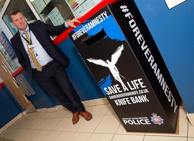 Detective Inspector Roger Edwards from GMP’s Violence Reduction Unit with a knife amnesty bin