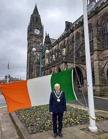 Mayor Billy Sheerin with the Irish tricolour flag outside the town hall on St Patrick's Day