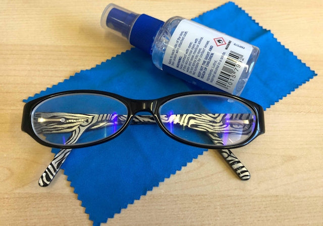 Glasses with cleaning solution and a cloth