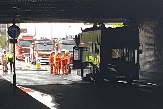 The roof of the double-decker bus came off in the collision with a railway bridge on Richard Street in Rochdale