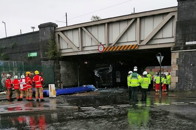 The roof of the double-decker bus came off in the collision with a railway bridge on Richard Street in Rochdale