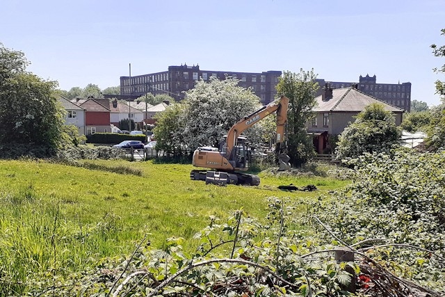 The digger on land near Woodland Road and Rye Street in Heywood