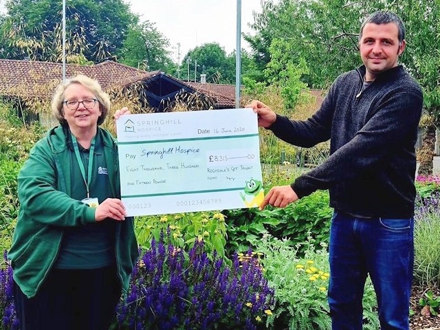 Paul Ellison presents a cheque for £8,315 to Barbara Lloyd from Springhill Hospice