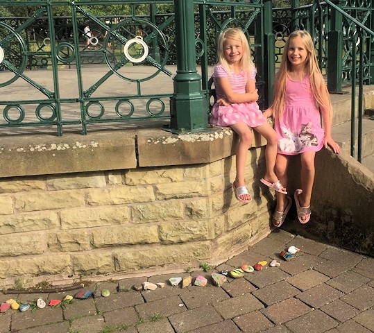 Maisie-Rae and Evie with the rock snake at the bandstand in Hare Hill Park