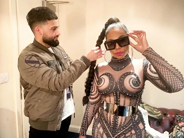 Mohammed Ilmaas does the Ashanti singer's hair before one of her concerts in the UK