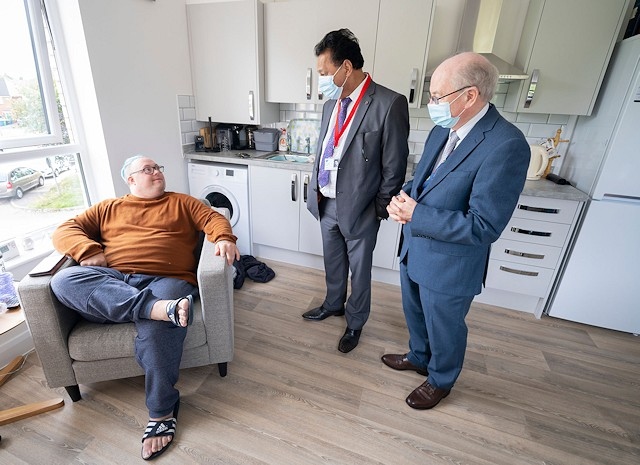 Ryan Banks in his new apartment, with Councillor Iftikhar Ahmed, cabinet member for adult care, and Councillor Billy Sheerin assistant cabinet member for adult care