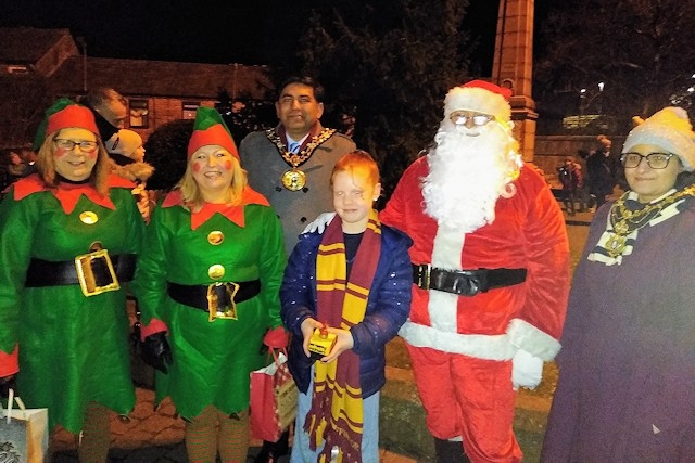 Rochdale Mayor Councillor Aasim Rashid, Summer-Rose Dixon and Mayoress Rifit Rashid at the Christmas Lights switch on event in Littleborough