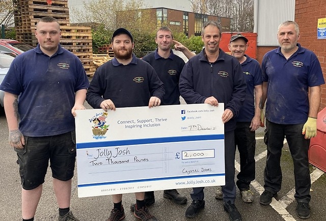 Richard Hagan (third right) with staff from Crystal Doors and their cheque for Jolly Josh