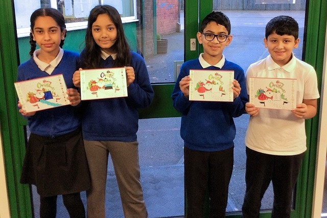 Children from Belfield Primary with their Christmas cards designed by Belfield Art Group