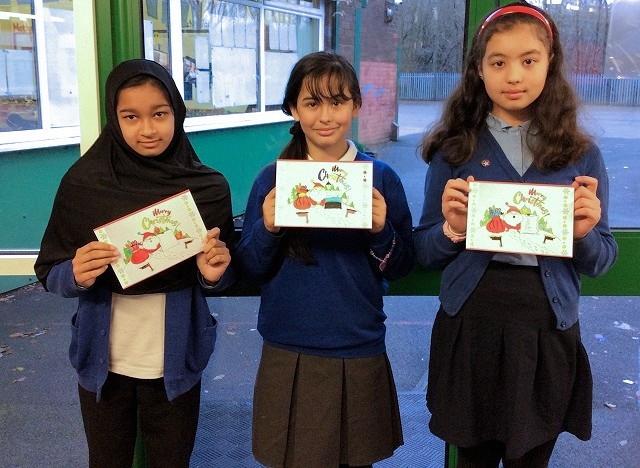 Children from Belfield Primary with their Christmas cards