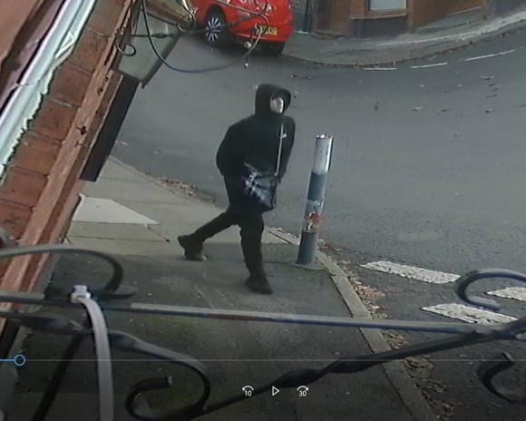 A CCTV image of a man police want to speak to in connection with an armed robbery in Heywood