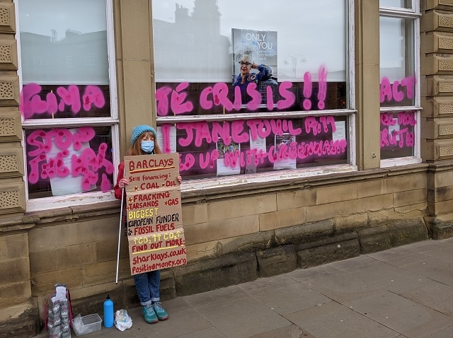 Extinction Rebellion activist Jane Touil protesting outside Barclays, Rochdale