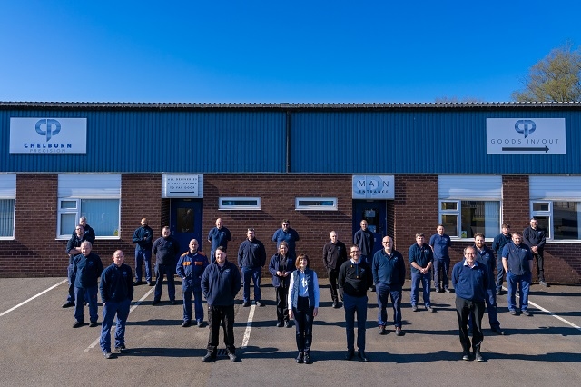 Chelburn Precision staff with managing director Neil Travis (front with glasses) and his wife Katie who is also a director