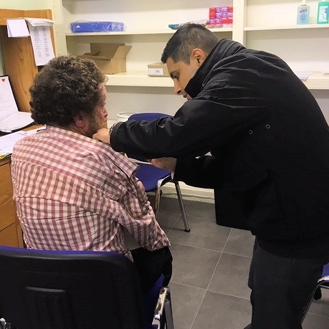 Dr Venk Mallya delivering flu vaccination at a local soup kitchen