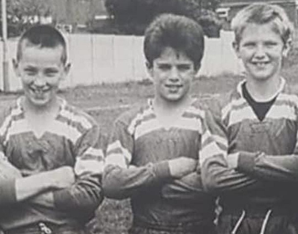 Young Daniel Kelly in his rugby gear (centre)