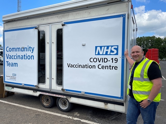 Councillor Phil Massey with the mobile Covid-19 vaccine unit in Kirkholt