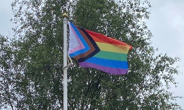 The LGBTQ+ Progress flag flying in the Pennines