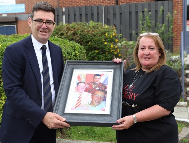 Mayor of Greater Manchester Andy Burnham and Lyn Rigby, mother of Fusilier Lee Rigby, holding photographs of the soldier