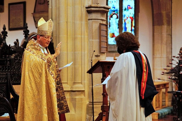 Bishop of Middleton, Rt Revd Mark Davies, blesses Revd Anne Gilbert at St Chad's on 29 June