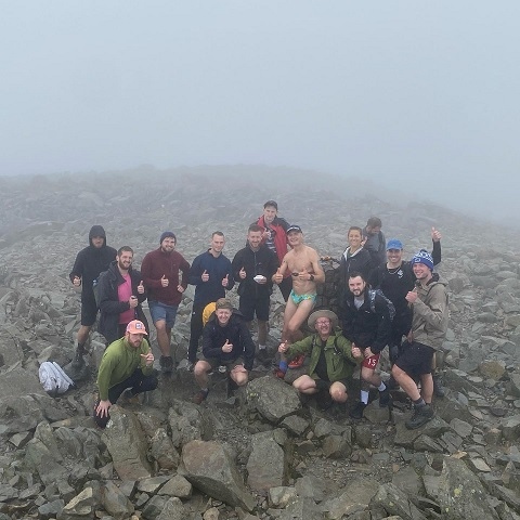 Gary Rothwell - wearing just his avocado Budgy Smugglers - at the summit of Scafell Pike with a crowd