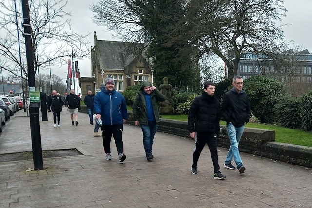 Football fans walk to Boundary Park, Oldham from the Crown Oil Arena